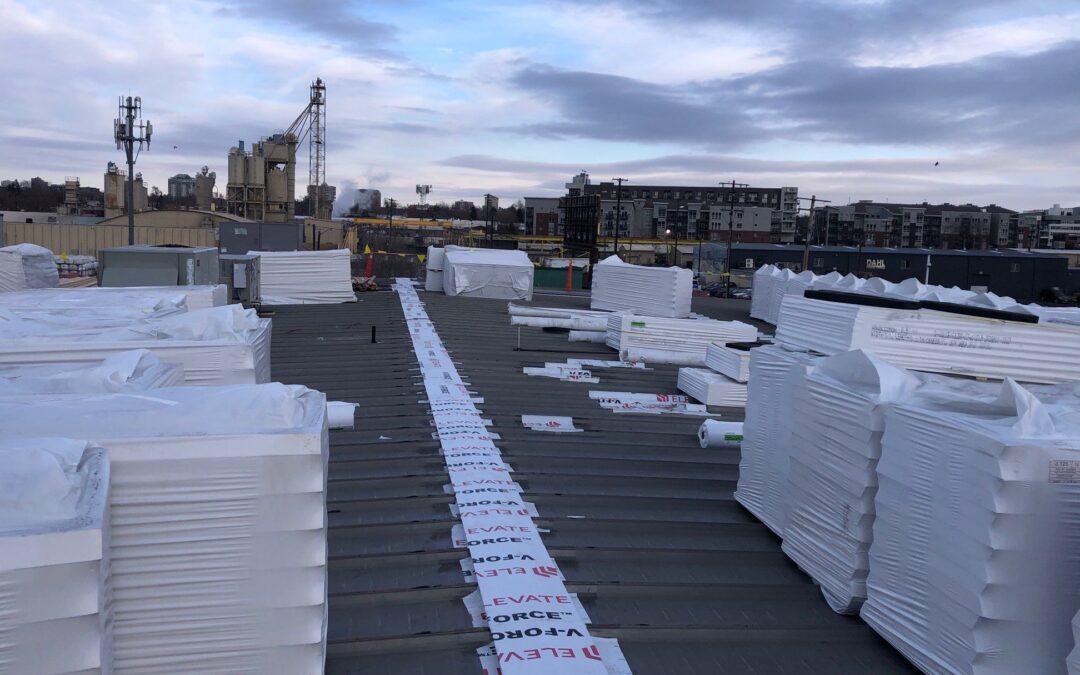 Roof insulation boards staged on a commercial rooftop in Denver
